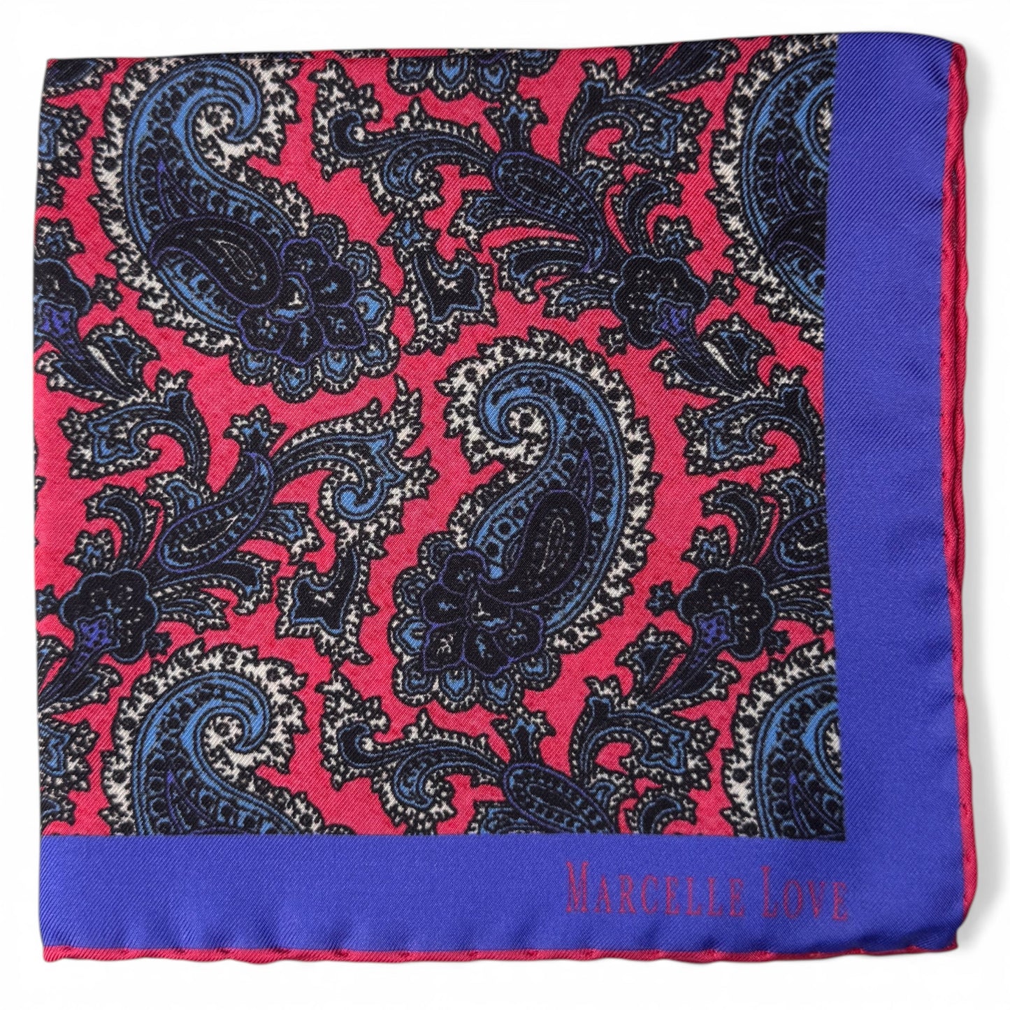 Paisley patterned pocket square with blue and red colors on a white background