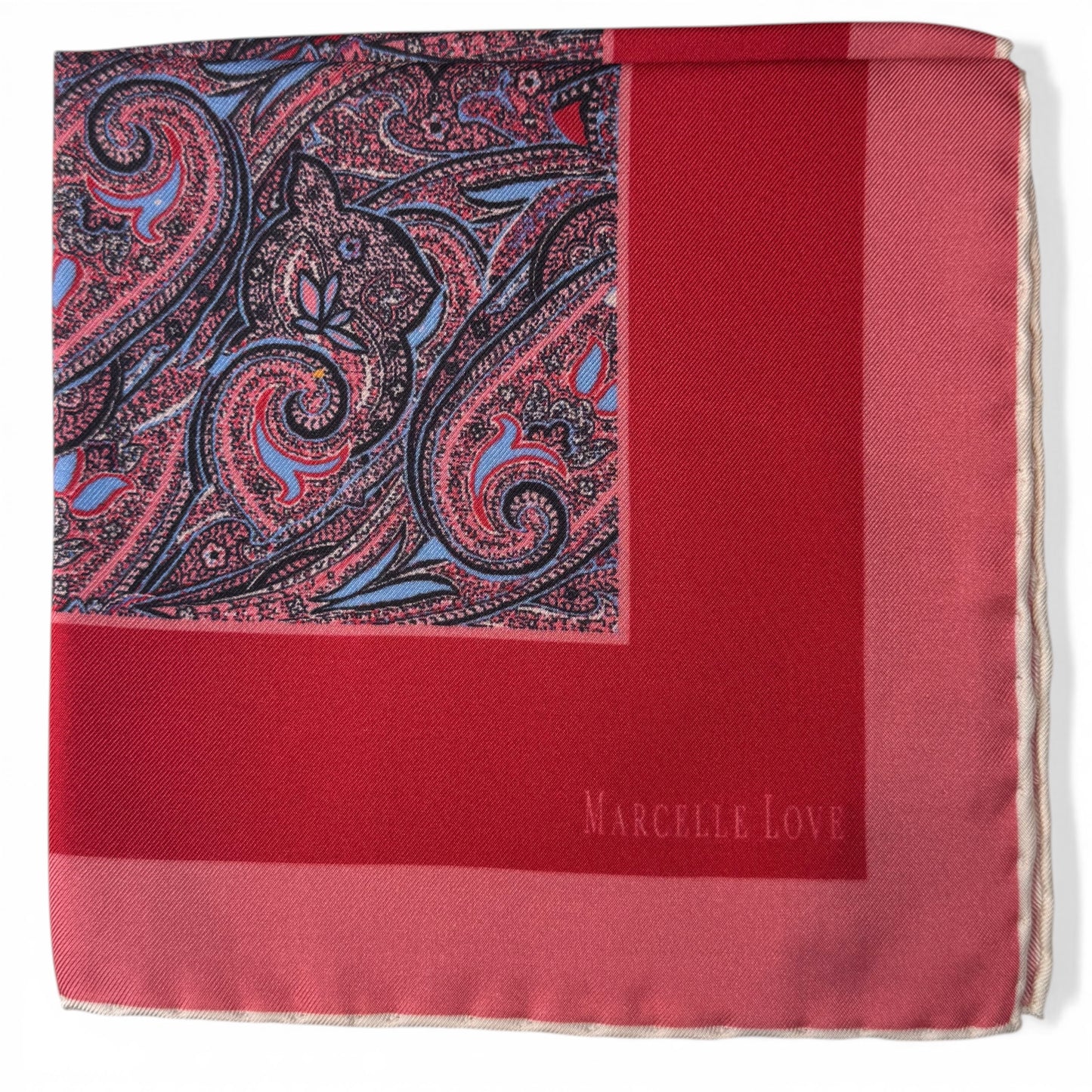 Red pocket square with paisley pattern and 'Marcelle Love' branding