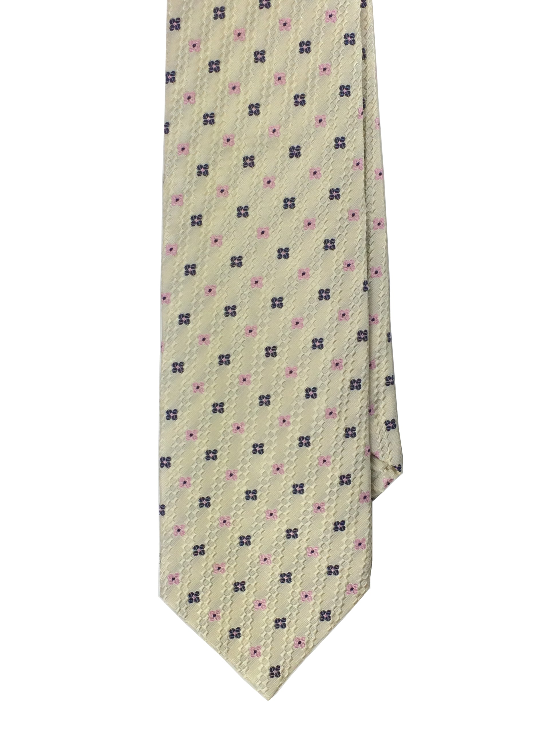 A cream-colored traditional woven tie with a navy blue pattern and a 4 leaf clover design,