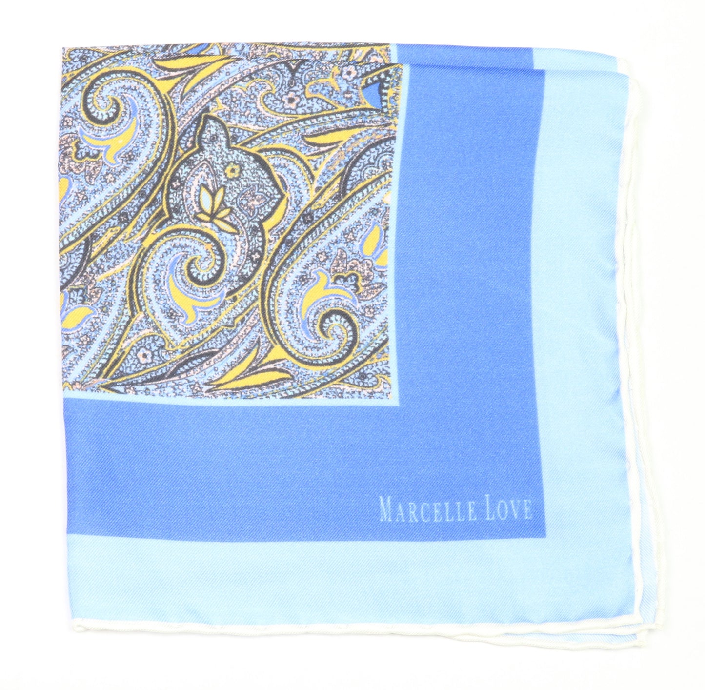 A blue pocket square with a paisley print and the brand name 'MARCELLE LOVE' printed at the bottom right corner.